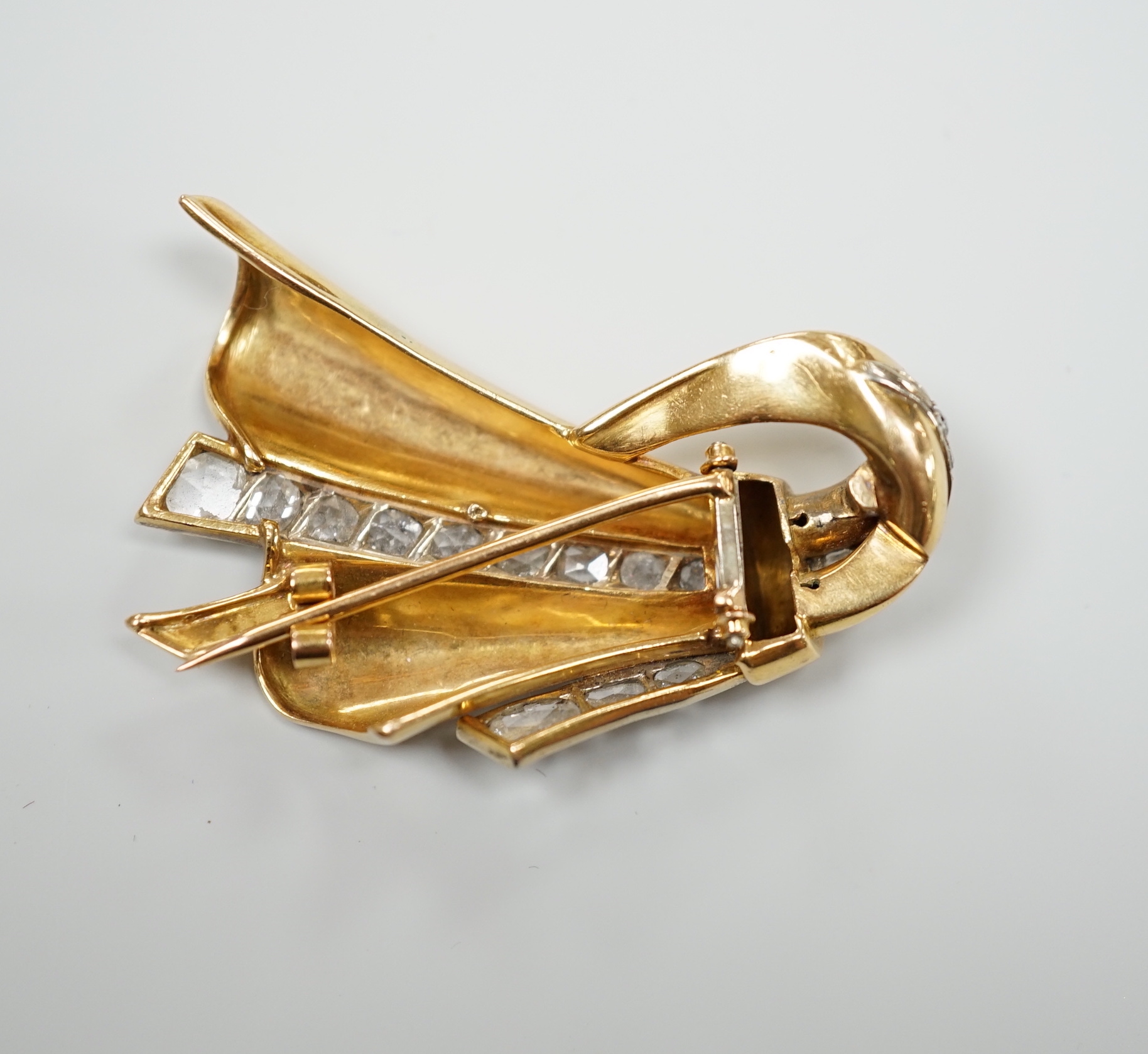 A 1940's/1950's French? yellow metal and graduated rose cut diamond set stylised fan clip brooch, 46mm (one pin missing)